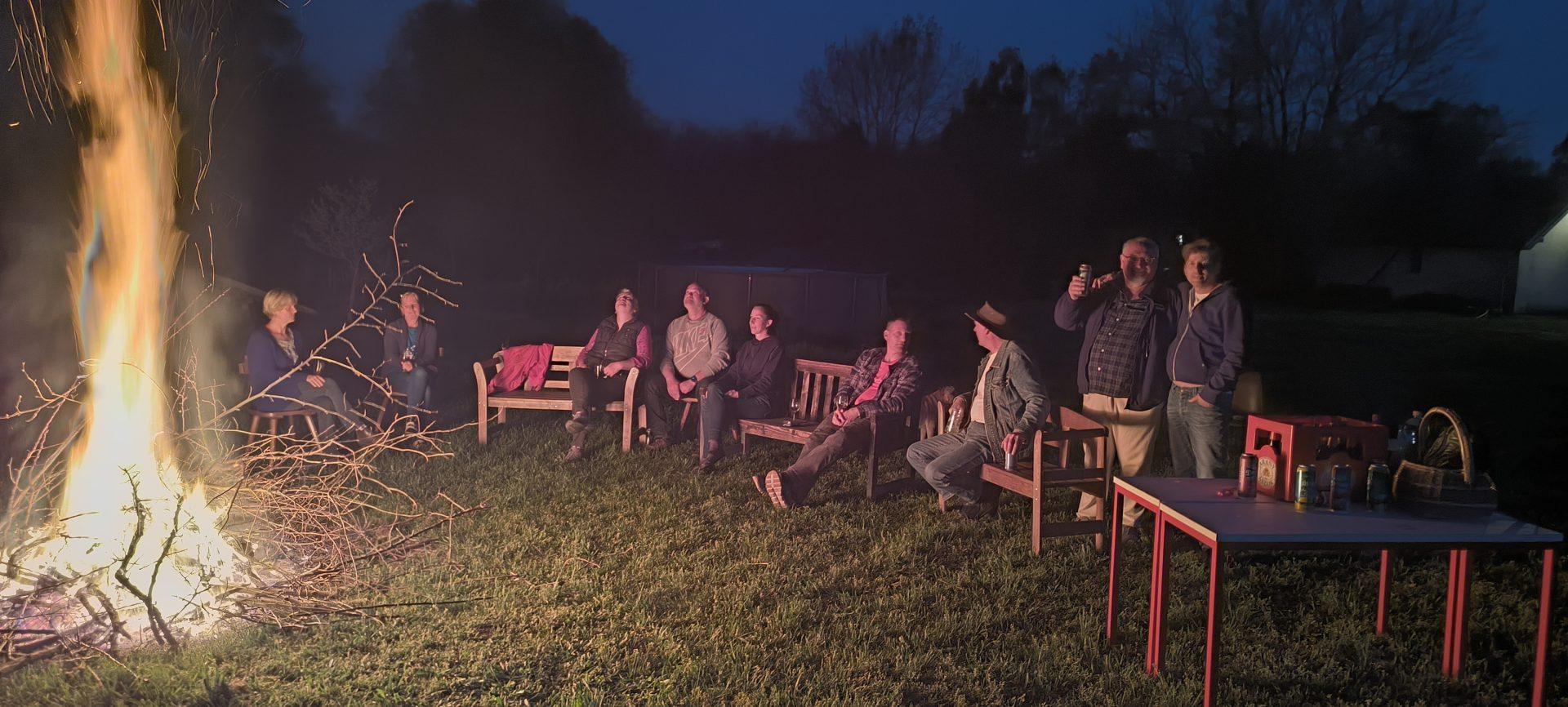 Gathering around the bonfire under the starry night sky