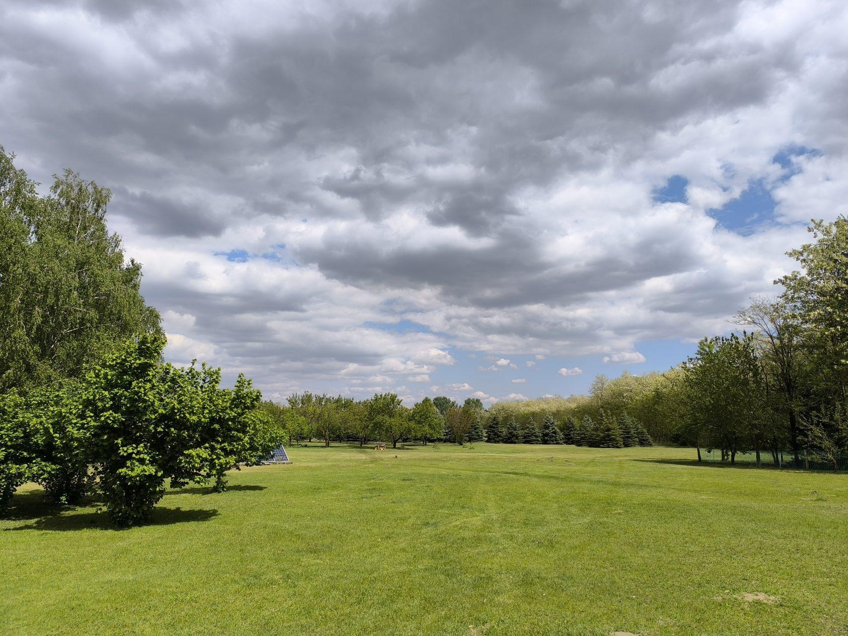 The expansive parkland under a dramatic spring sky