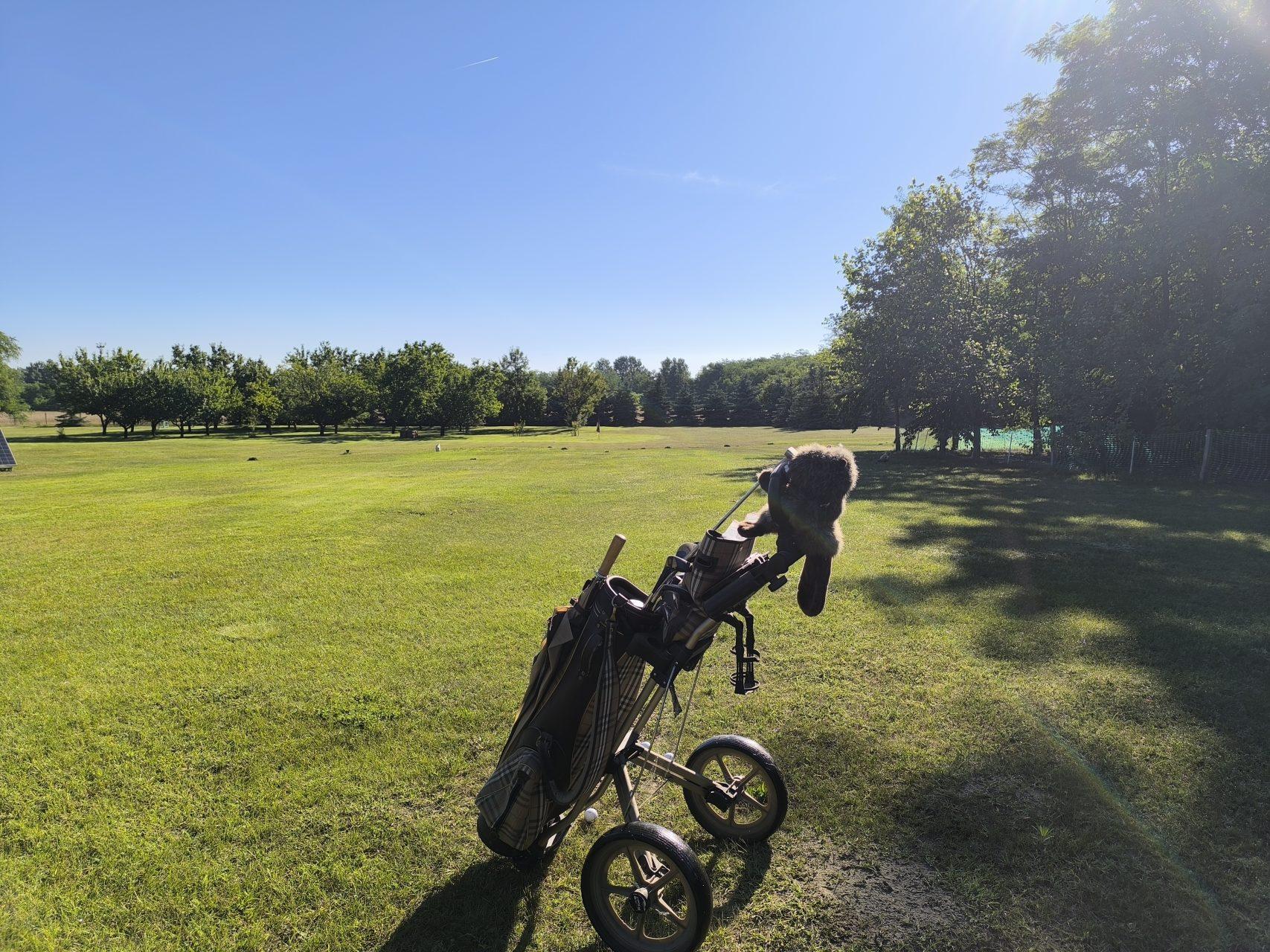 Golf equipment ready for a round on the sun-drenched lawn