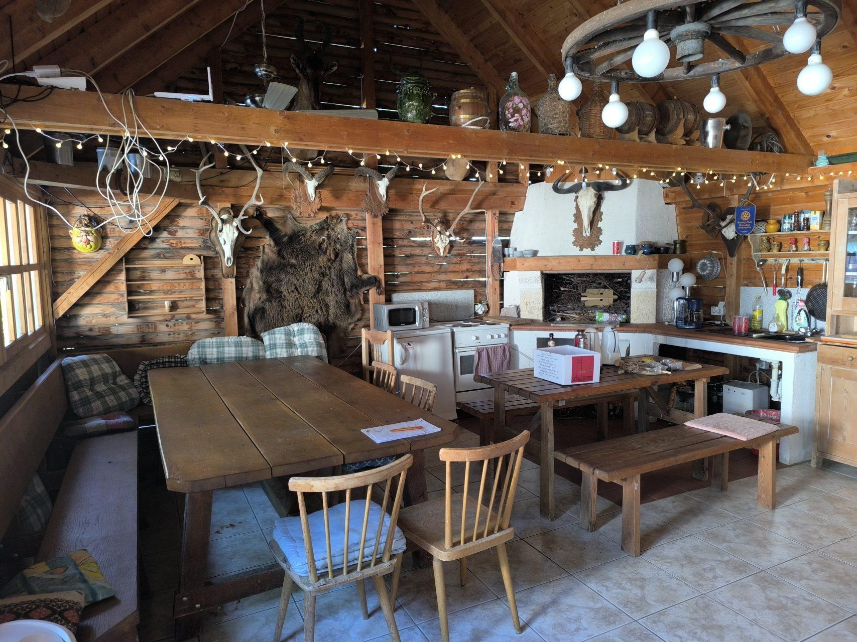 The community kitchen with open fireplace, wooden beams and country charm
